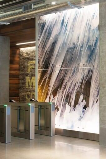 The final installation of this masterpiece of architectural glass artwork was designed by Suzanne Tick, photographed by Bonnie Edelman, and printed on the glass in the lobby of 1k Fulton by Skyline Design architectural glass manufacturer.