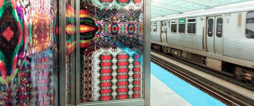 Abstract custom glass windbreaks on the platform and wall-cladding in the station at the CTA Green Line Garfield stop. Artwork designed by Chicago artists Nick Cave and Bob Faust, photographed by Scott Shigley, and printed on glass by Skyline Design.